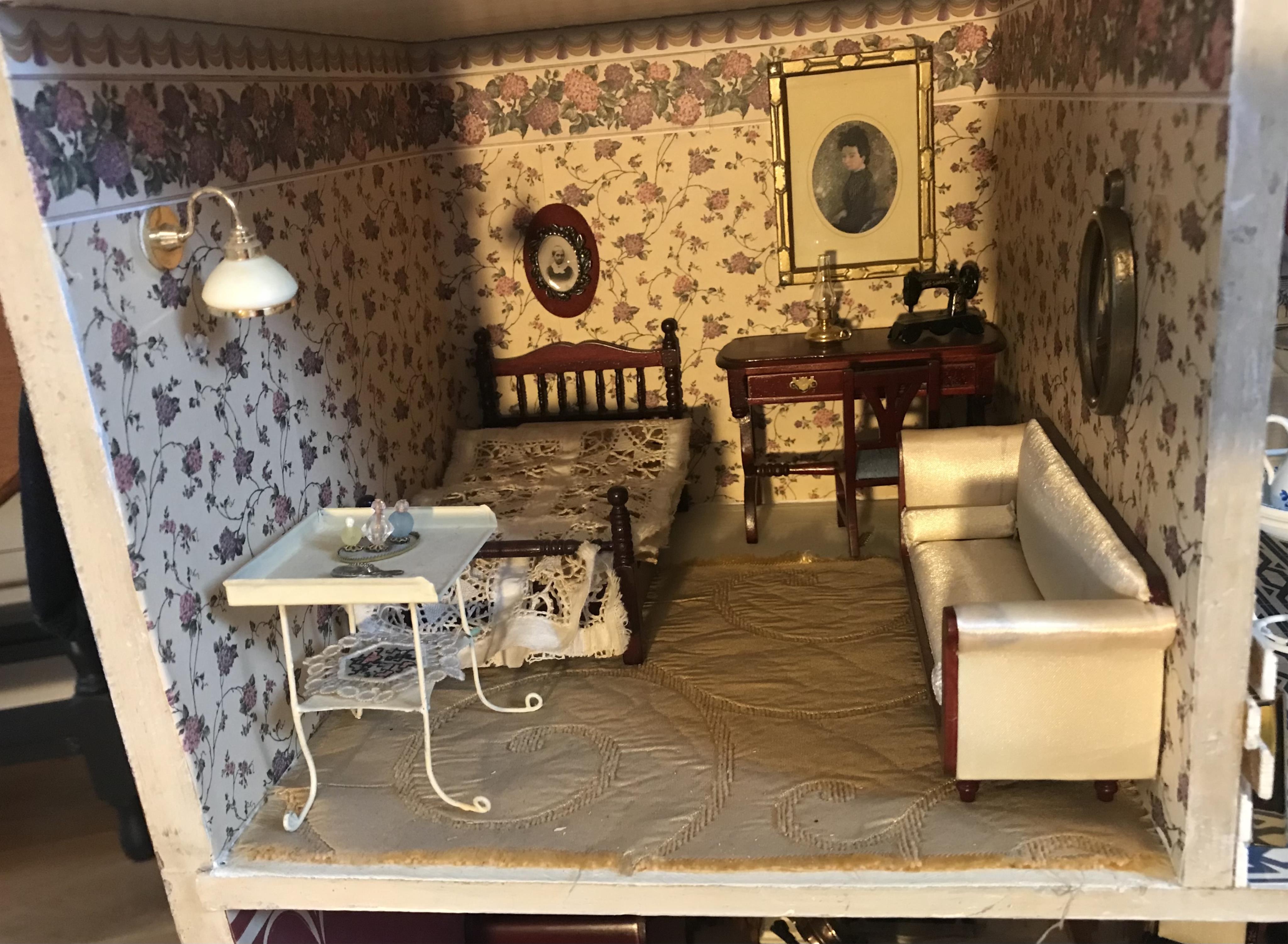 A late 19th century doll's house, with a single front opening panel, incorporating eight internal rooms, flat roof with parapet, dimensions 81.5cm high, 79cm wide, 30cm deep, together with modern manufactured furniture a